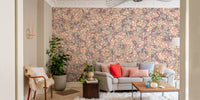 Multicolor Poesies Flowers wallpaper mural of vintage florals behind a grey sofa with coral pillows in a living room