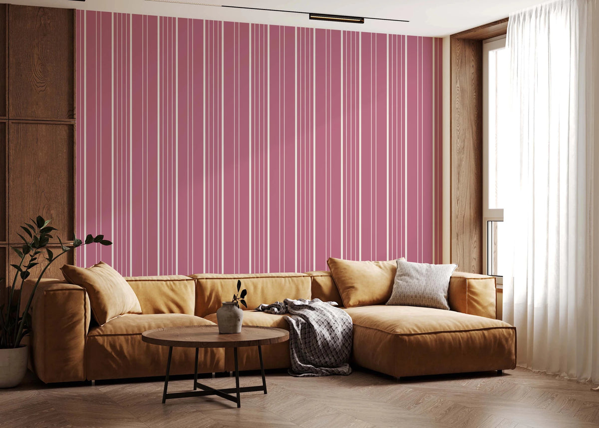 Muted Pink Stripes wallpaper with cream pinstripes behind a tan leather sectional sofa in a warm living room