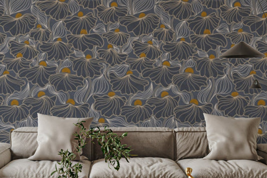 Flowing Meadow Night wallpaper in slate blue with gold floral accents above a beige sectional sofa in a living room