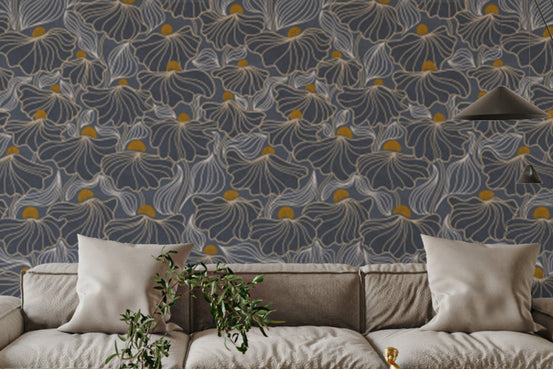 Flowing Meadow Night wallpaper in slate blue with gold floral accents above a beige sectional sofa in a living room