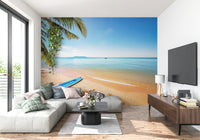 Na Jomtien wallpaper mural of a beach with a blue paddleboard behind a grey sectional in a living room