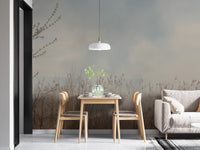 Natural Reeds wallpaper mural of misty grasses behind a wood dining table and gray sofa in a dining nook