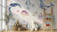 Nautical Creatures wall mural of pastel sea life behind a white teddy bear and wicker toy baskets in a nursery
