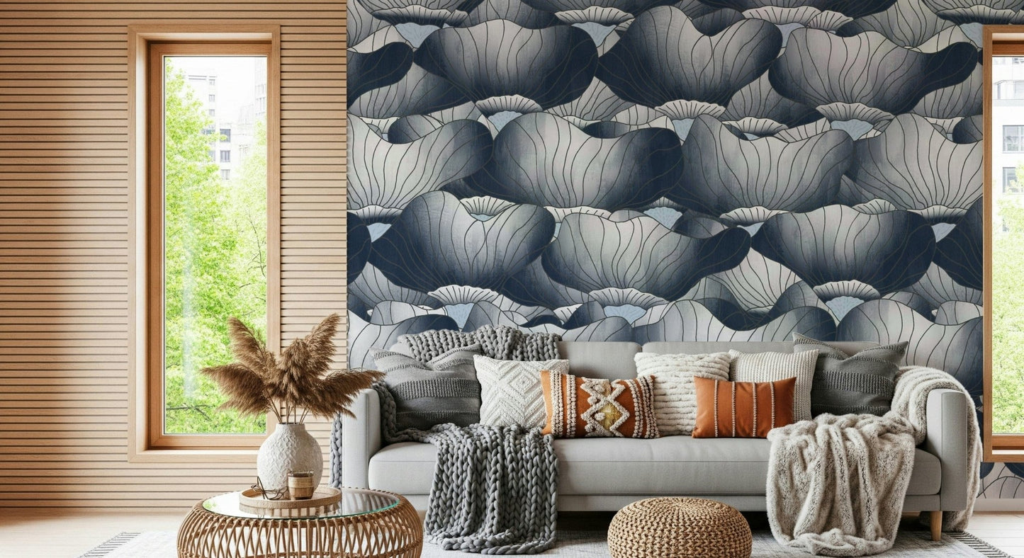 Navy Blue Botanical Bloom Waves wallpaper behind a grey sofa piled with boho cushions beside pampas grass and a wood window