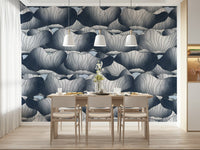 Navy Blue Botanical Bloom Waves wallpaper behind a light wood dining table and chairs under three white pendant lights