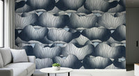 Navy Blue Botanical Bloom Waves wallpaper in deep blue behind a white sofa with a round table and small succulent
