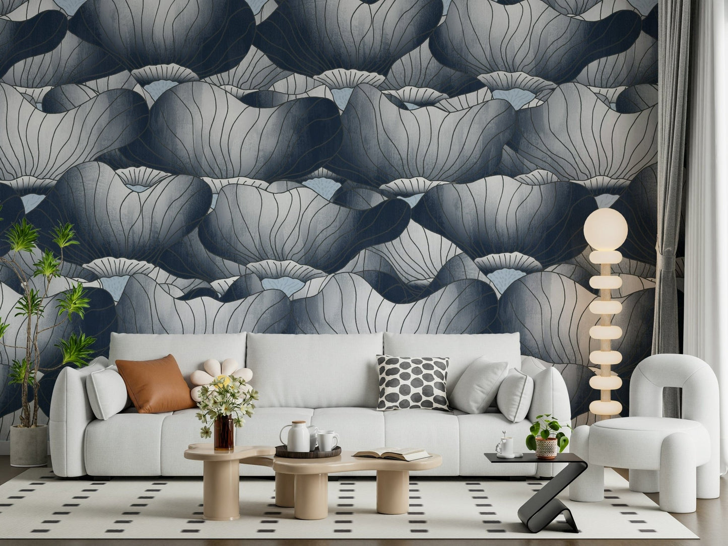 Navy Blue Botanical Bloom Waves wallpaper of inky lotus blooms behind a white sofa with a beaded floor lamp