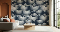 Navy Blue Botanical Bloom Waves wallpaper behind a grey sofa with rust cushions beside a terracotta arch and tall window