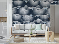 Navy Blue Botanical Bloom Waves wallpaper behind a white sofa with a round wood coffee table and woven pouf on a jute rug