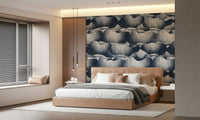 Navy Blue Botanical Bloom Waves wallpaper in navy and slate behind a tan leather bed with slim black pendant lights