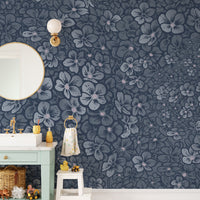 Navy Blue Garden Flower wallpaper mural above a mint vanity and round mirror in a kids bathroom