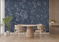 Navy Blue Garden Flower wallpaper mural behind a round wood table and beige chairs in a dining room