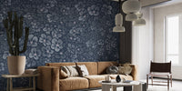 Navy Blue Garden Flower wallpaper mural behind a tan suede sofa and tall cactus in a living room