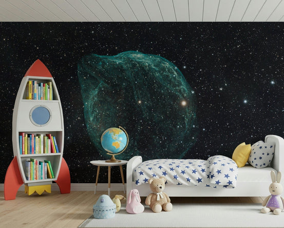 Stellar Cloud wallpaper mural with teal nebula on black starfield in a kids room with red rocket bookshelf and star bed