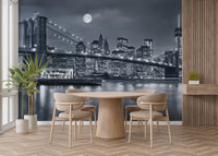 New York City Night View wallpaper mural of the skyline behind a round wood table and chairs in a dining room