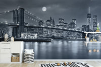 New York City Night View wallpaper mural with Brooklyn Bridge and full moon behind a white dresser in a kids room