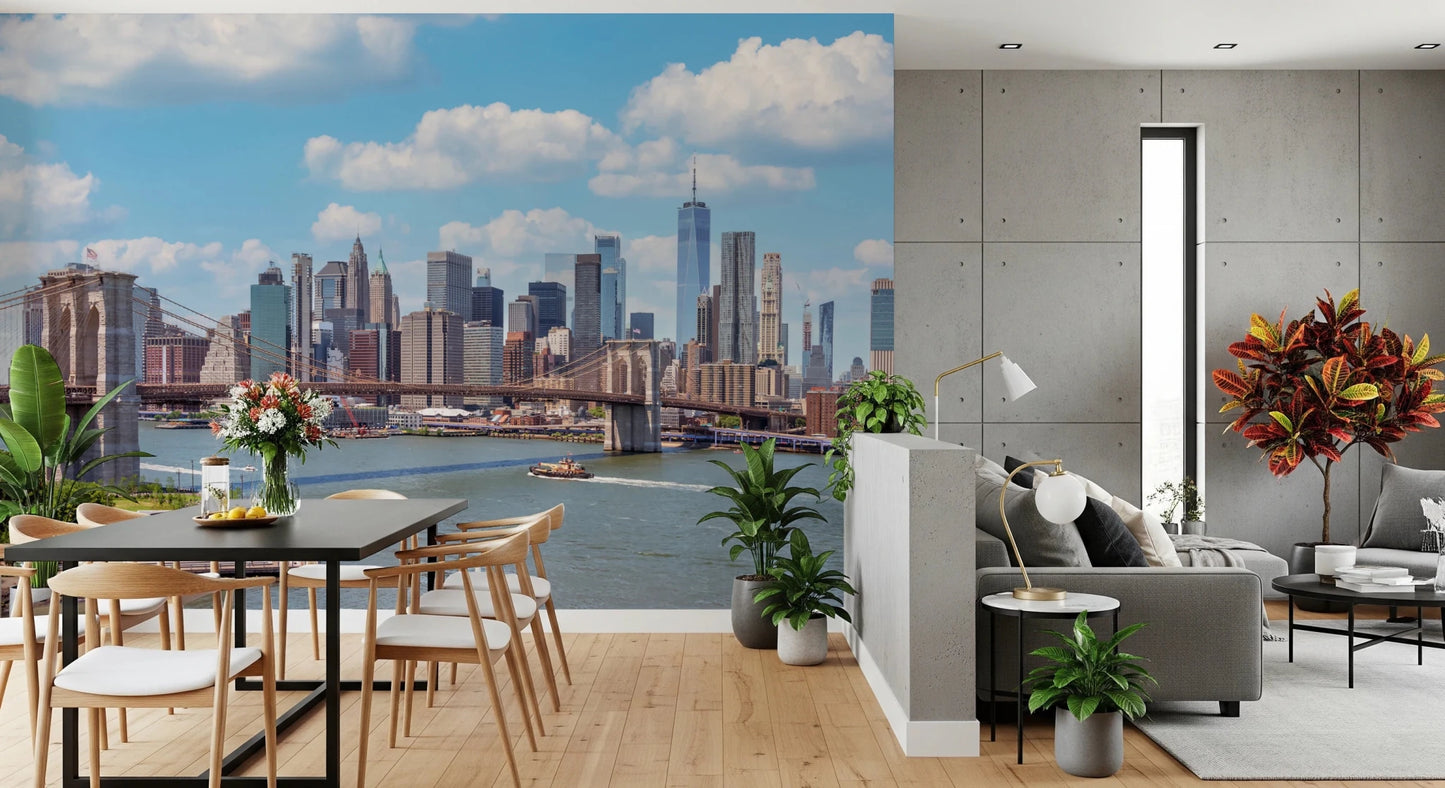 NYC Bridge Vista wallpaper mural of the bridge and skyline above a black dining table beside a grey sofa