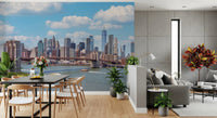 NYC Bridge Vista wallpaper mural of the bridge and skyline above a black dining table beside a grey sofa