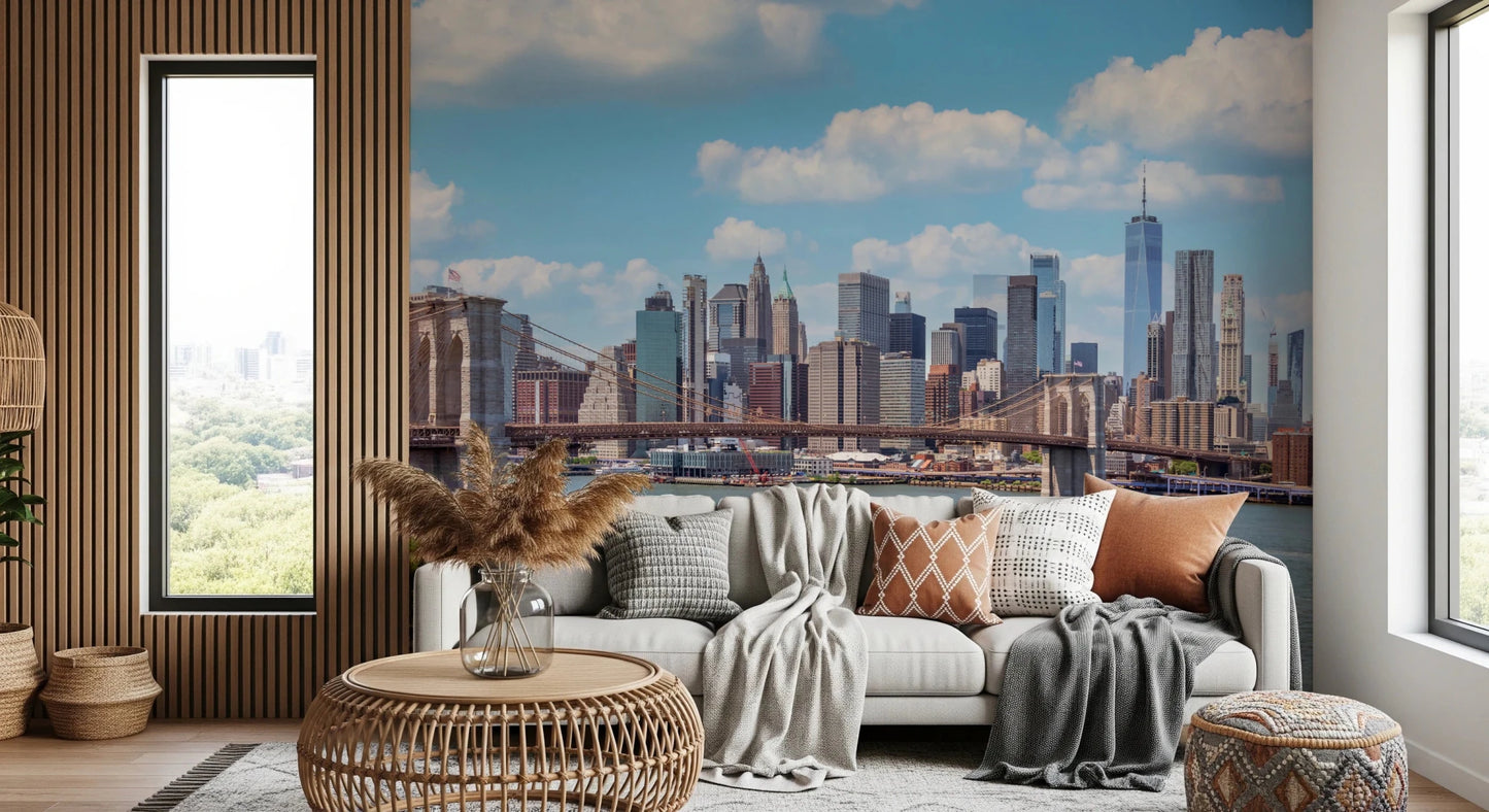 NYC Bridge Vista wallpaper mural of the Manhattan skyline behind a white sofa and rattan table in a living room
