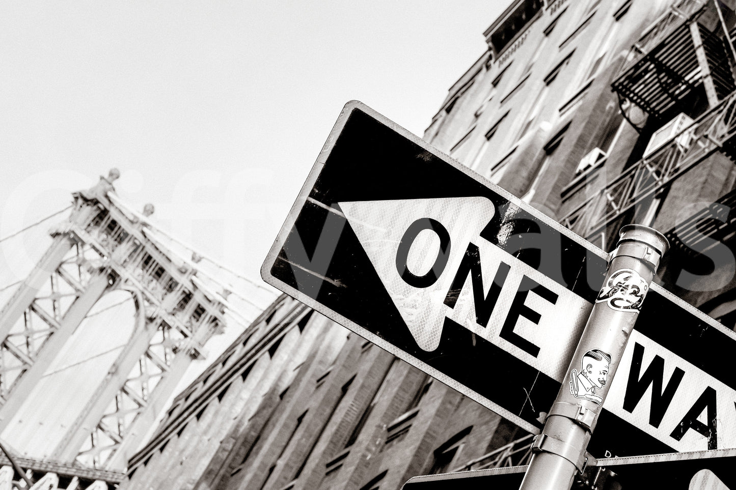 Urban Direction NYC wallpaper mural close-up of a black and white One Way sign with the Manhattan Bridge behind