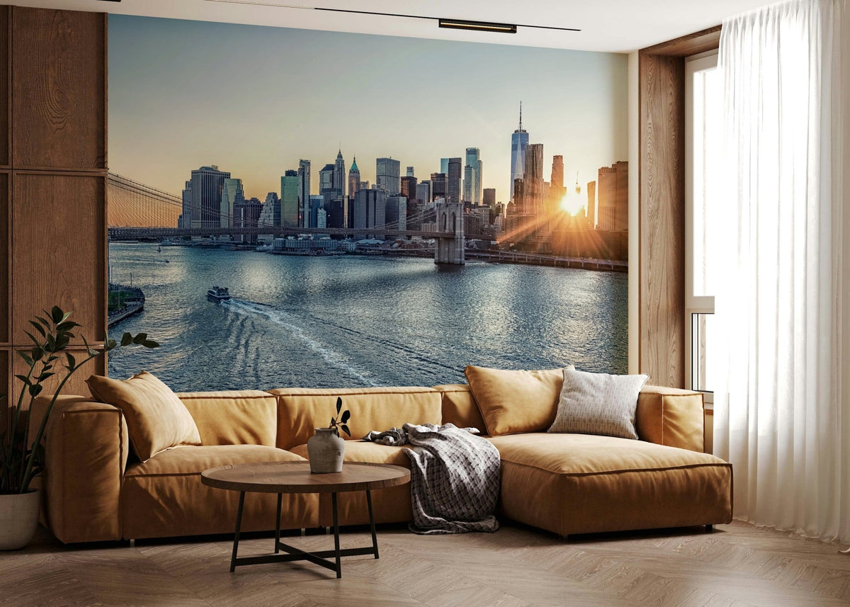 NYC Skyline at Dawn wallpaper mural of Manhattan and the bridge at sunrise behind a caramel sectional sofa in a living room
