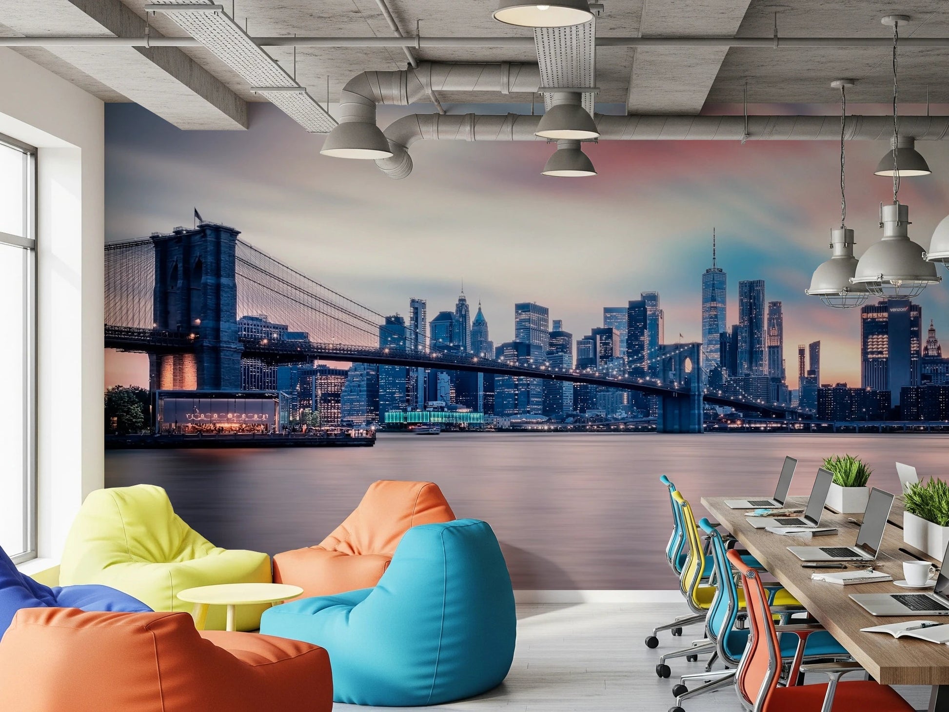 NYC Twilight Dreams wallpaper mural of Brooklyn Bridge above colorful beanbag chairs in an open office