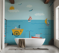 Ocean with Lighthouse and Boat wallpaper mural as a bedroom feature wall behind the headboard in blue tones