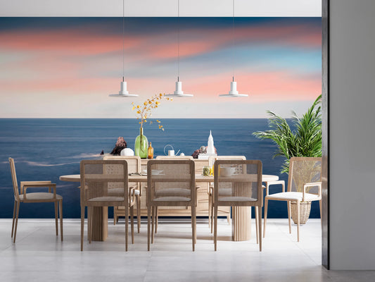 Sunset ocean wall mural above modern dining set