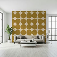 Warm neutral wallpaper with oversized ochre round shapes arranged in rows and columns