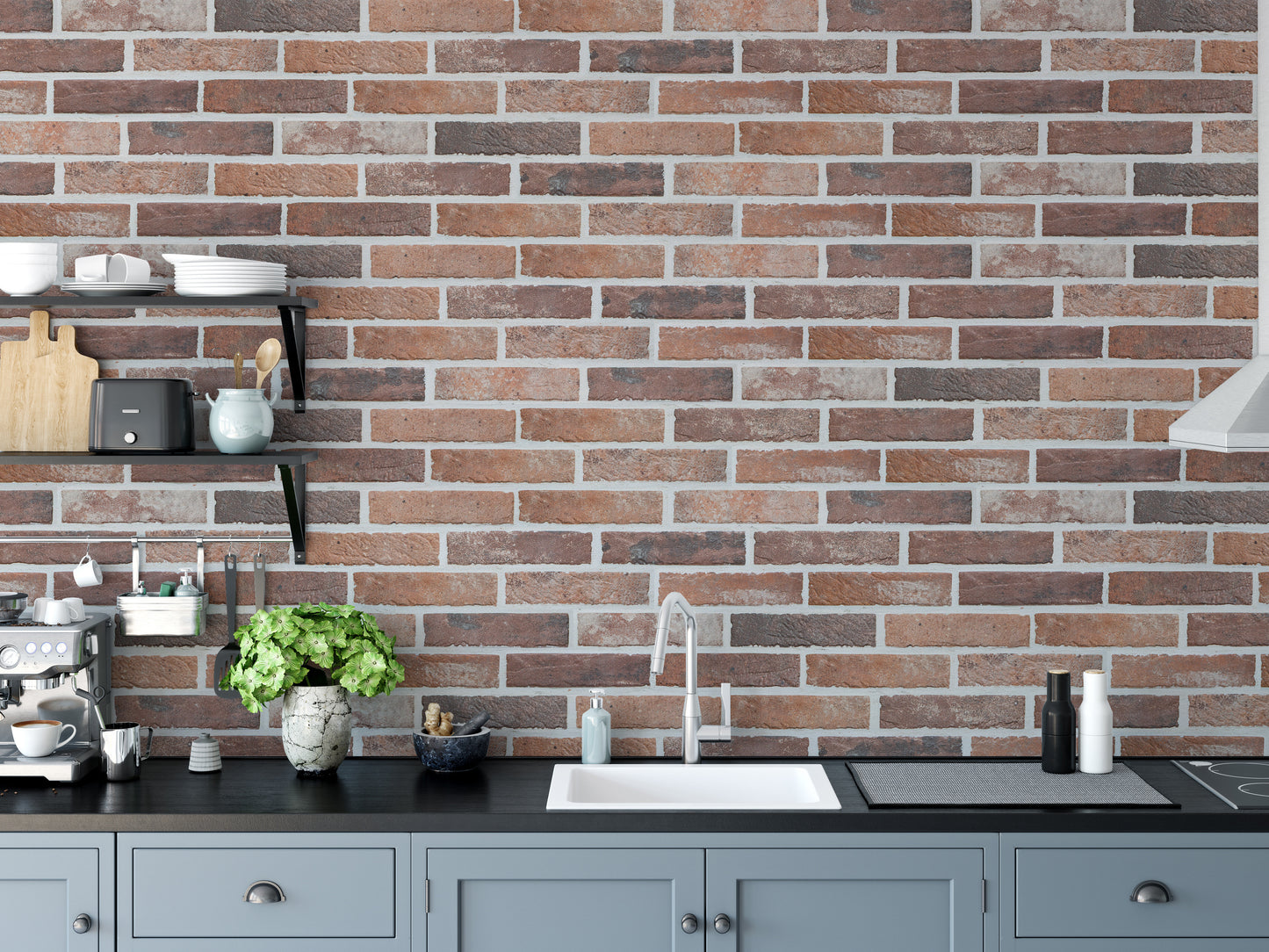 Old Dirty Red Brick wallpaper mural above grey kitchen cabinets and a black counter with a sink and green plant