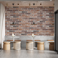 Old Dirty Red Brick wallpaper mural in a cafe with white round tables, rattan stools and black pendant lamps