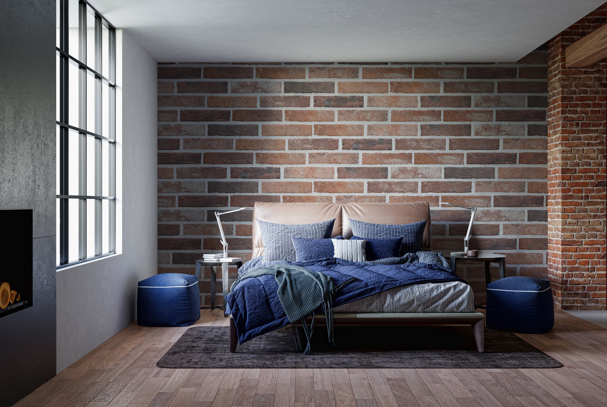 Old Dirty Red Brick wallpaper mural in an industrial bedroom behind a bed with blue bedding and blue poufs
