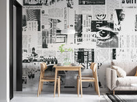 Urban Newsprint wallpaper mural of black-and-white headlines behind a light-wood dining table and chairs