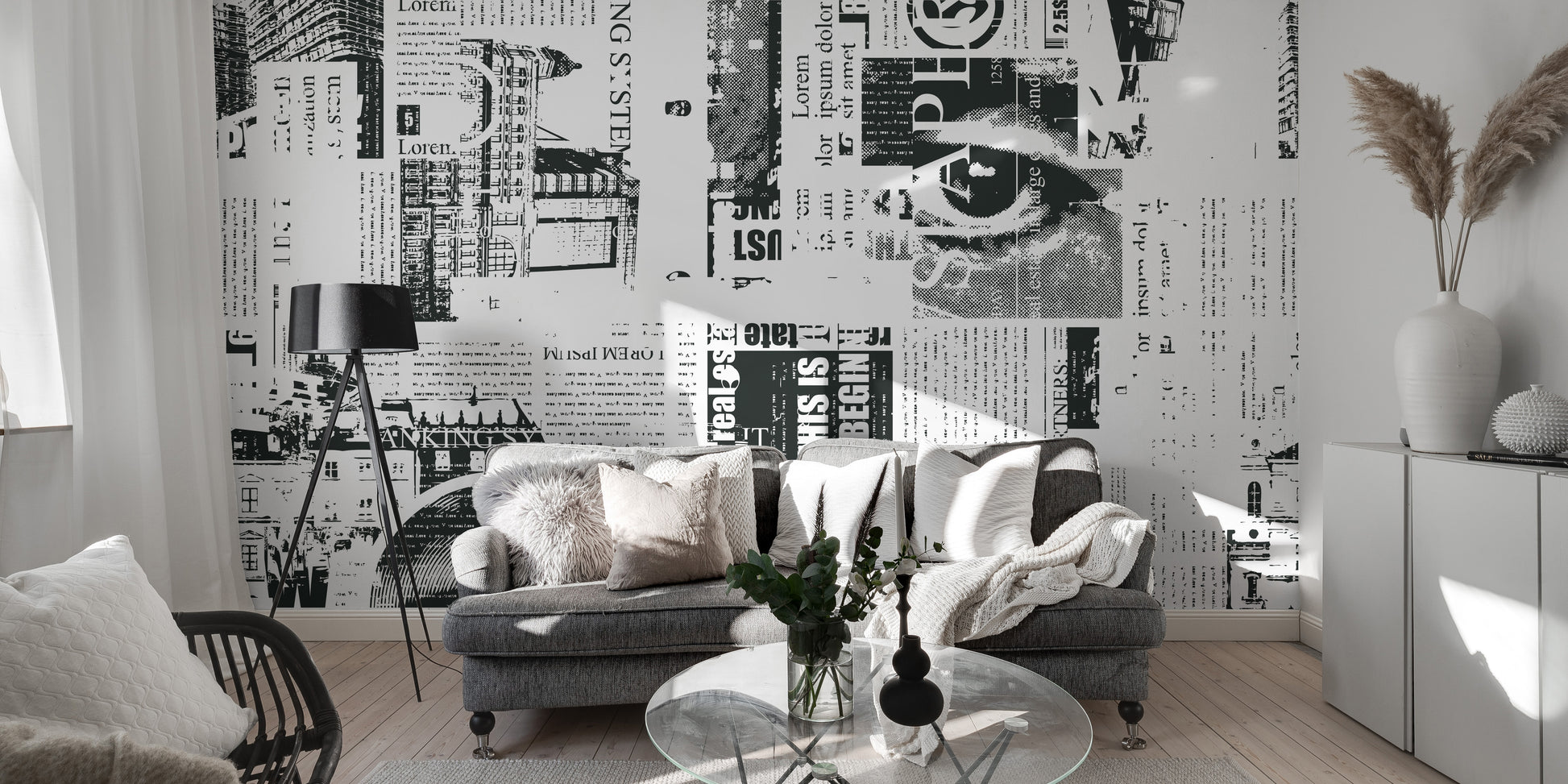 Urban Newsprint wallpaper mural in monochrome newspaper print behind a grey sofa and tripod lamp in a living room
