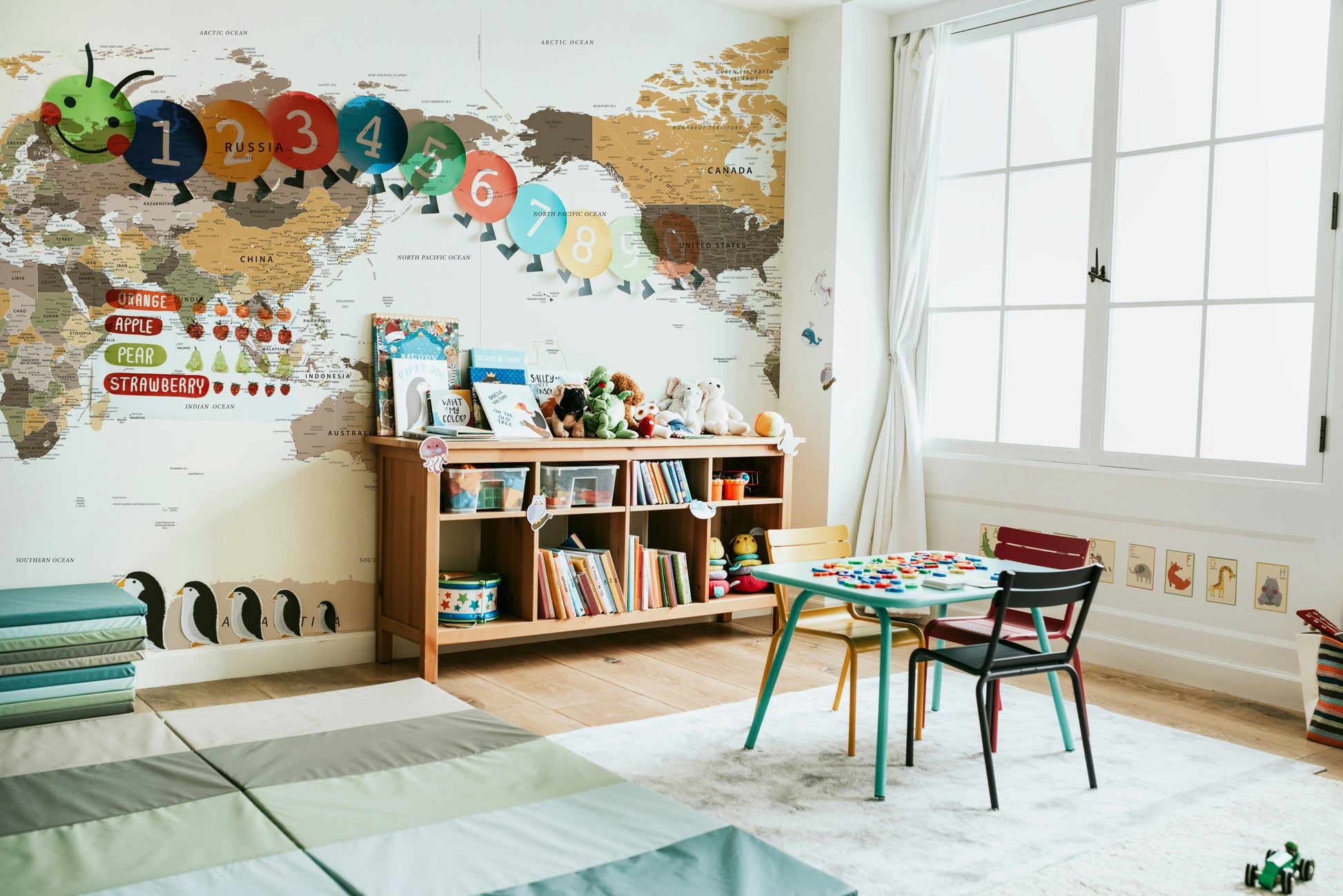 Pacific Centered Travel Map wallpaper mural with caterpillar number decals in a kids playroom
