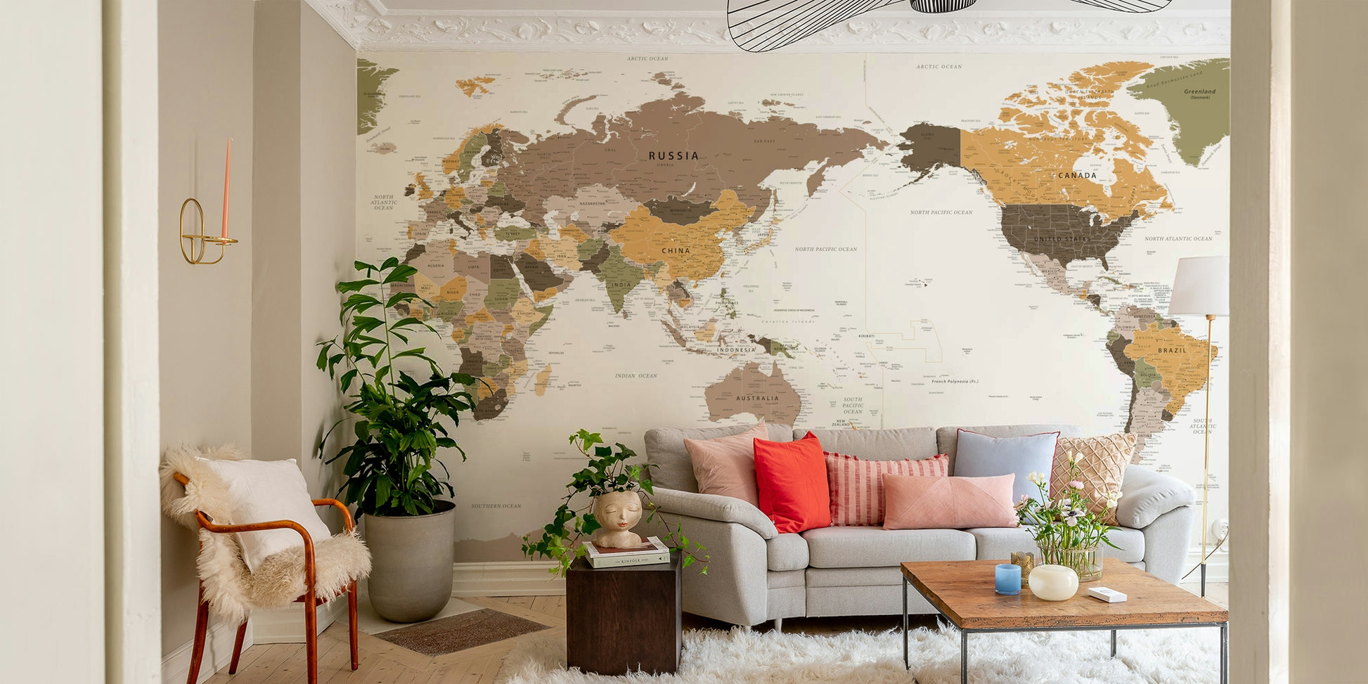 Pacific Centered Travel Map wallpaper mural above a light gray sofa with coral pillows in a living room
