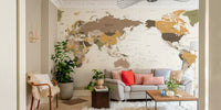 Pacific Centered Travel Map wallpaper mural above a light gray sofa with coral pillows in a living room