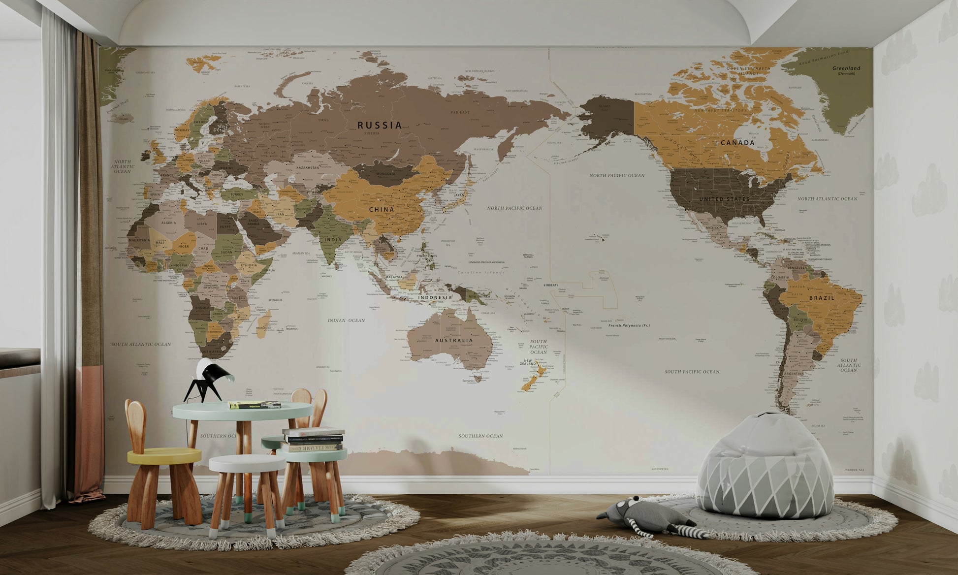 Pacific Centered Travel Map wallpaper mural in a kids room with a mint toddler table and gray bean bag