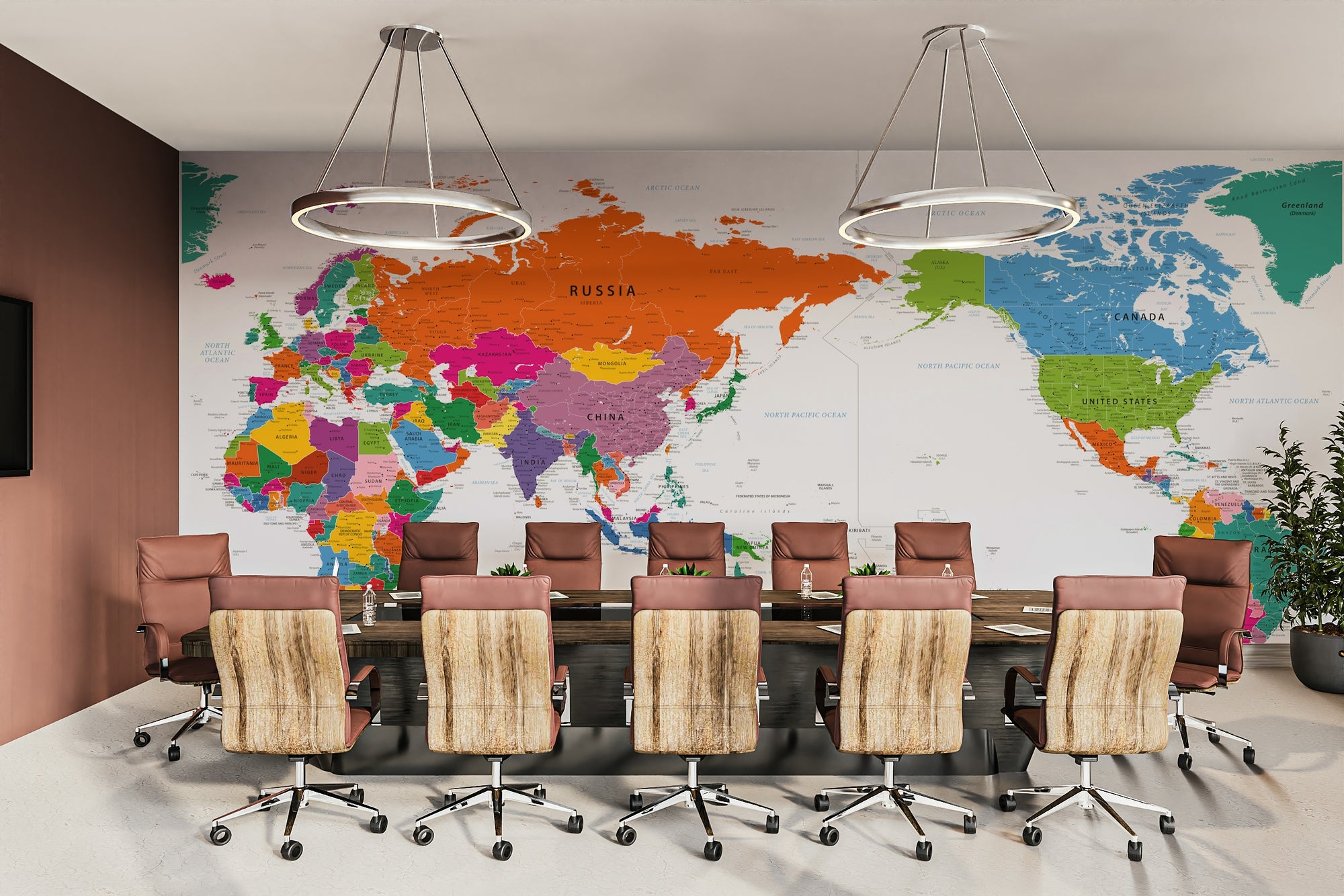 Pacific Centered World Map Fun Colors wallpaper mural in a meeting room above a long table and leather chairs