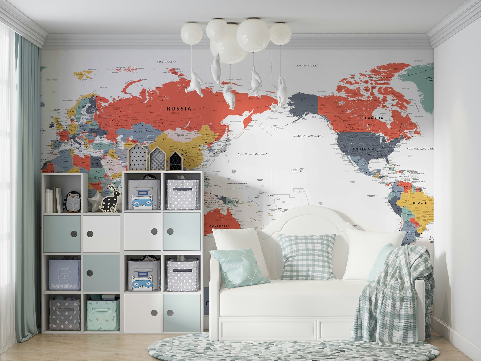 Pacific Centered World Map in Happy Colors wallpaper mural in a kids room with cube storage bins and a white daybed
