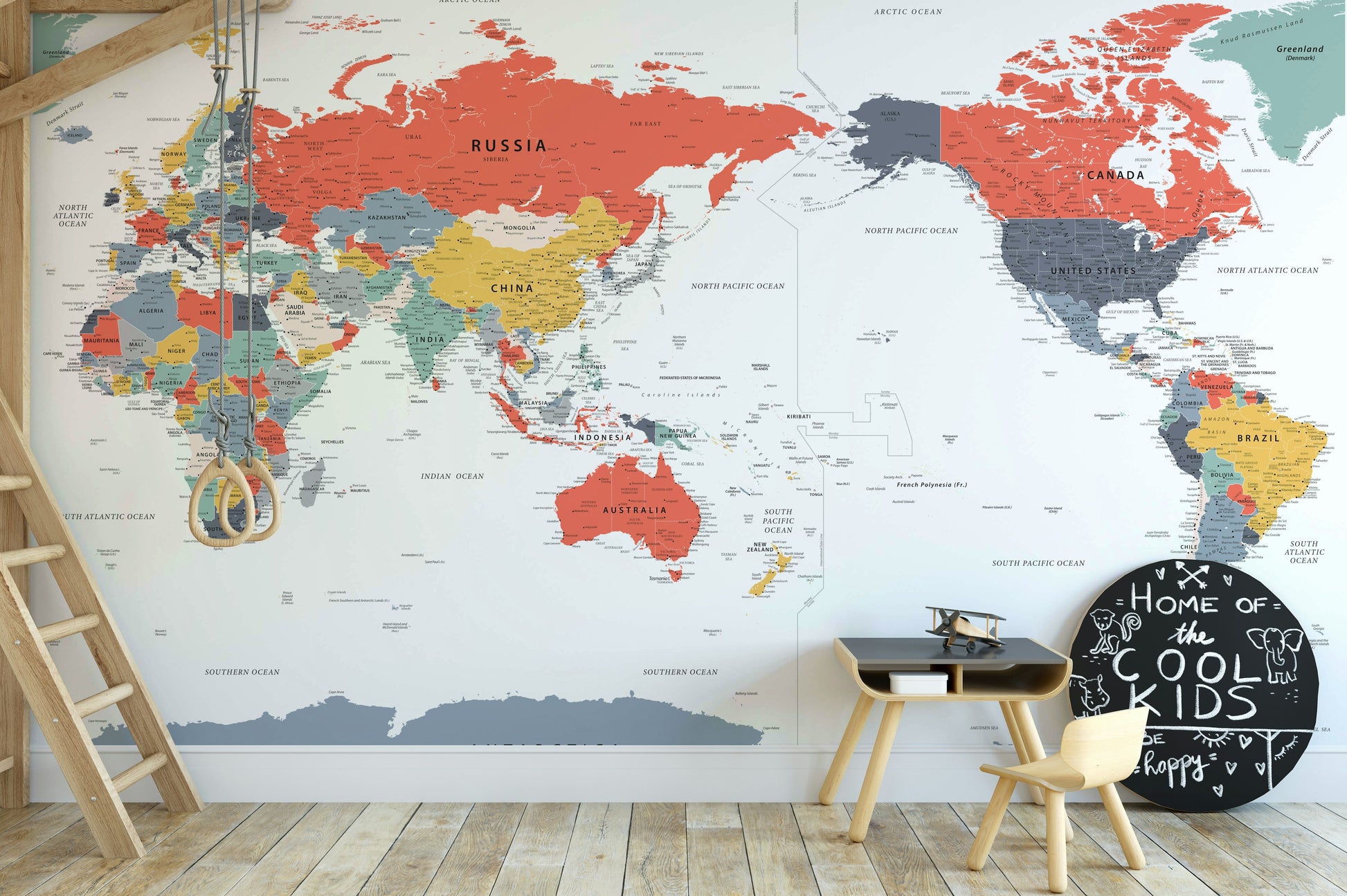 Pacific Centered World Map in Happy Colors wallpaper mural in a kids room with a loft-bed ladder and chalkboard