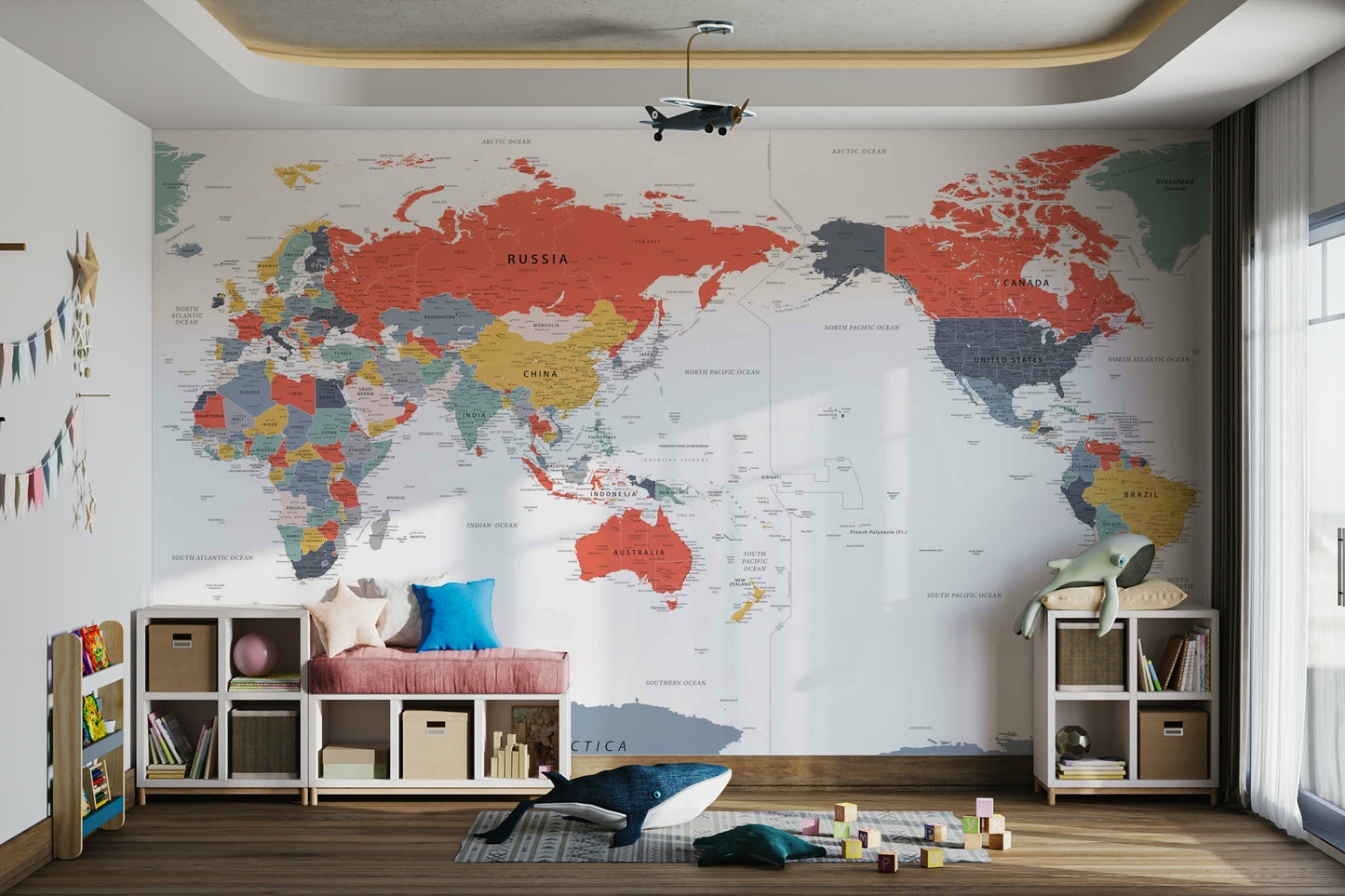 Pacific Centered World Map in Happy Colors wallpaper mural in a bright kids room with a pink bench and toy plane