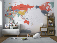 Pacific Centered World Map in Happy Colors wallpaper mural over a white loveseat with owl pillows and a polar bear toy