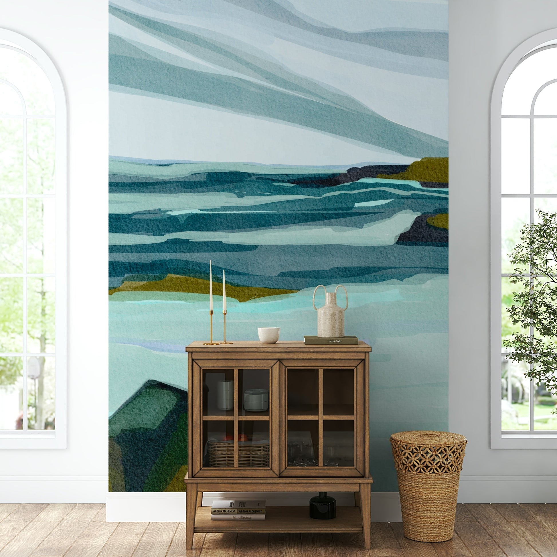 The mural is installed in a calm living room behind a simple, light-colored sofa.

