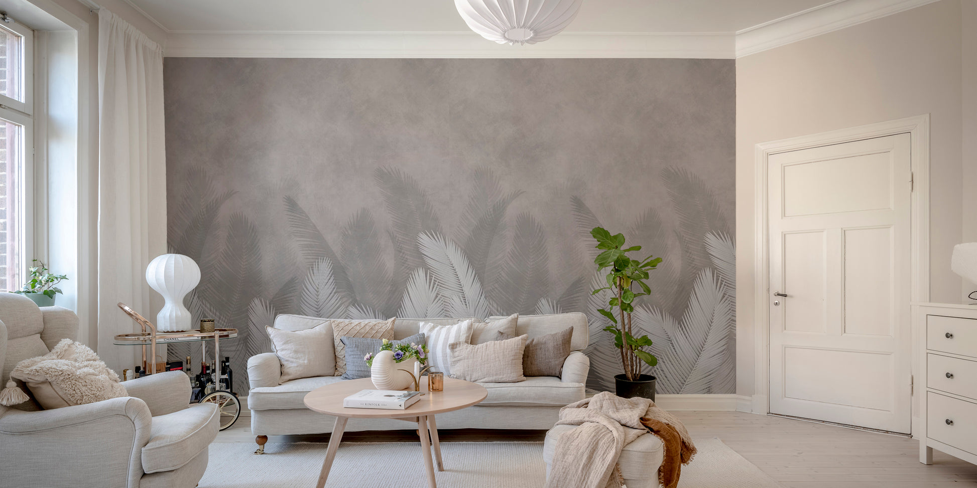 Palm leaves with gray color wallpaper mural as a feature wall in a home office workspace in white tones