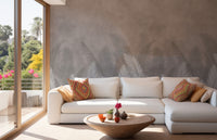 Palm leaves with gray color wallpaper mural styled as a feature wall behind a dining table and chairs in white tones