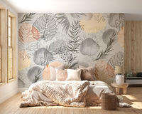 Palm tropical leaves wallpaper mural of abstract foliage above a cozy bed with a chunky knit throw