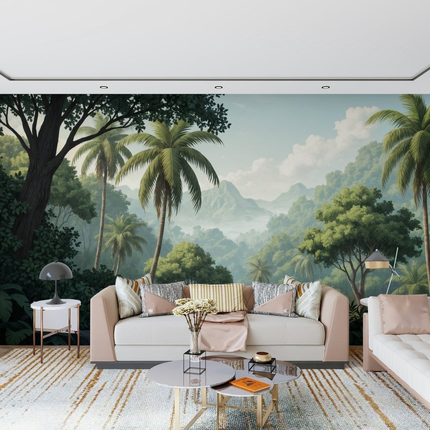 Palm Vista wallpaper mural of a jungle valley behind a blush cream sofa on a gold-striped rug in a living room