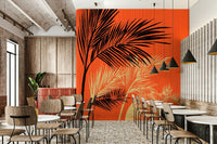 Palms at Sunset wallpaper mural with black palm fronds on orange in a cafe with wood bistro chairs