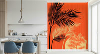 Palms at Sunset wallpaper mural of black palms and a sun on orange beside a kitchen dining table with blue chairs